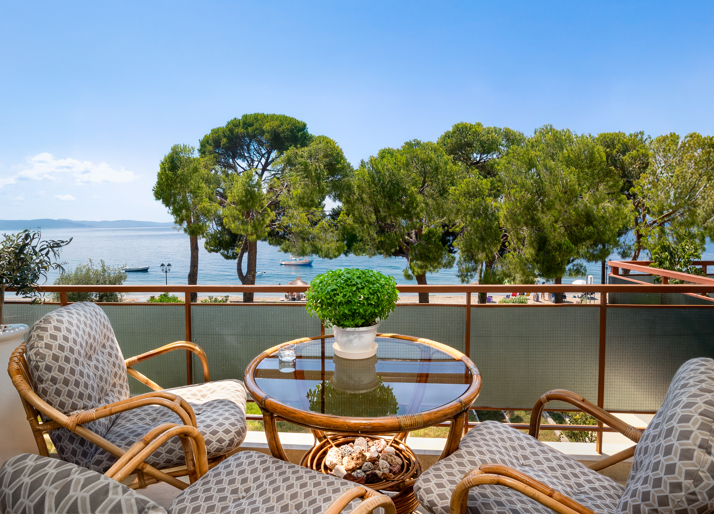 Poseidon balcony with wicker chairs overlooking the beach and sea